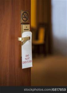 do not disturb sign hanging on open door in a hotel