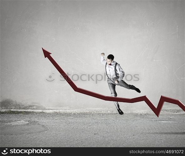 Do not let it rise. Angry businessman breaks big red growing arrow