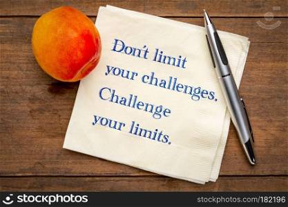 Do not limit your challenges. Challenge your limits. Inspirational handwriting on napkin with a fresh apricot.