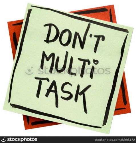 do not multitask - efficiency advice or reminder - handwriting on an isolated sticky note