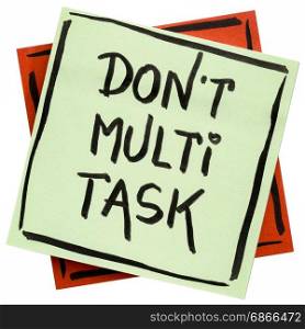 do not multitask - efficiency advice or reminder - handwriting on an isolated sticky note