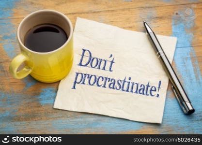 do not procrastinate reminder - handwriting on a napkin with a cup of coffee