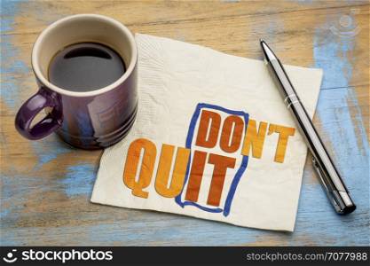 Do not quit - do it word abstract on a napkin with a cup of espresso coffee