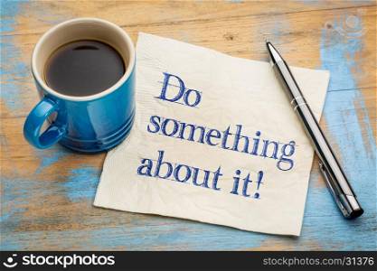 Do something about! Handwriting on a napkin with a cup of espresso coffee