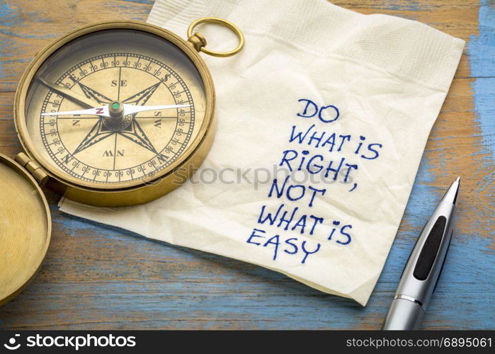 Do what is right, not what is easy advice or reminder - handwriting on a napkin with an antique brass compass