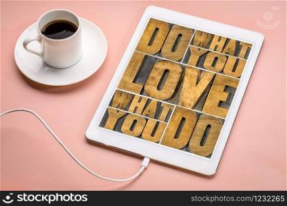 do what you love, love what you do - motivational word abstract in vintage letterpress wood type on a digital tablet with coffee, happiness, career, satisfaction and success concept