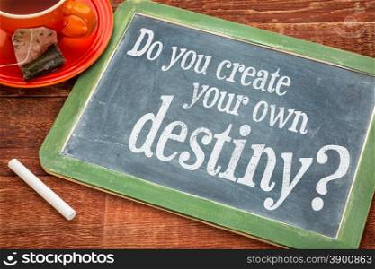 Do you create your own destiny question on a slate blackboard with chalk and cup of tea
