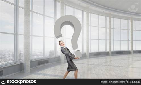 Do you have question. Attractive businesswoman carrying big stone question mark