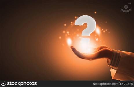 Do you have question. Close up of male hand holding question mark icon