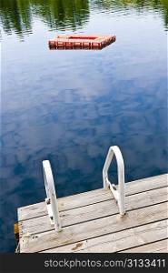 Dock on calm lake in cottage country