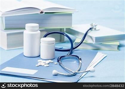 Doctor accessories and medications on blue background