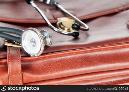 Doctor&acute;s brown leather case with the stethoscope