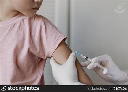 doctor administering vaccine kid