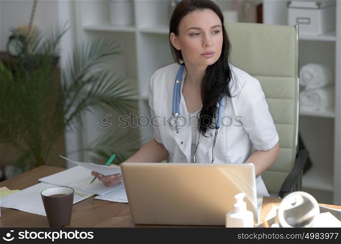 Doctor analyzing medical test results of her patient at her office
