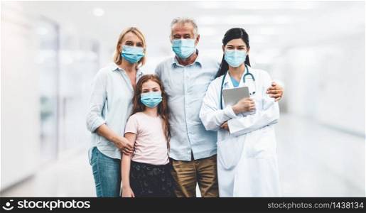 Doctor and family wear face mask in hospital protect from COVID-19. People health care and medicine concept.