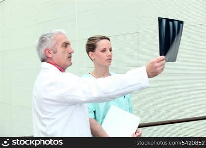 Doctor and his assistant examining an x-ray