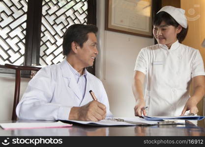 Doctor and Nurse at Desk