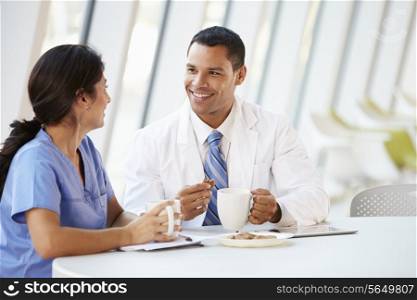 Doctor And Nurse Chatting In Modern Hospital Canteen