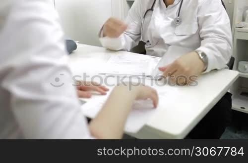 Doctor and nurse discussing analyses actively