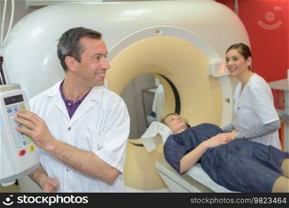 doctor and nurse examining woman with ct scanner