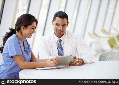 Doctor And Nurse Having Informal Meeting In Hospital Canteen