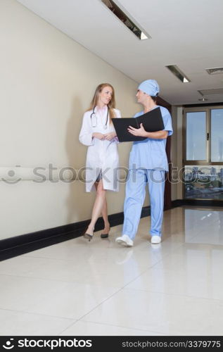 Doctor and nurse reading information from database