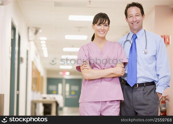 Doctor And Nurse Standing In A Hospital Corridor