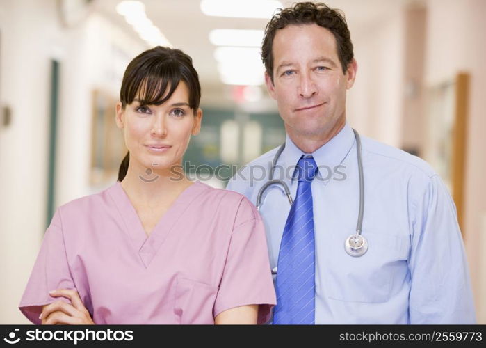 Doctor And Nurse Standing In A Hospital Corridor