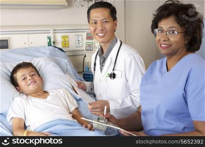 Doctor And Nurse Visiting Child Patient On Ward