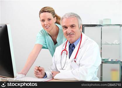 Doctor and nurse working at a computer
