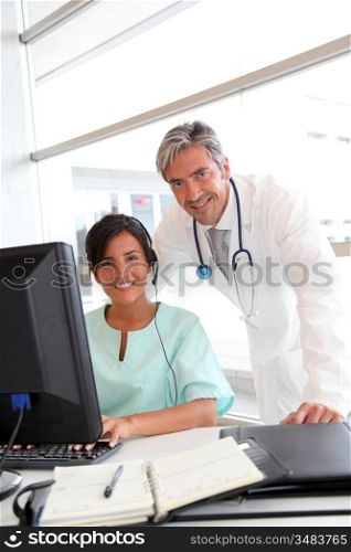 Doctor and nurse working in office