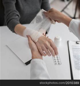 doctor arranging hand bondage patient