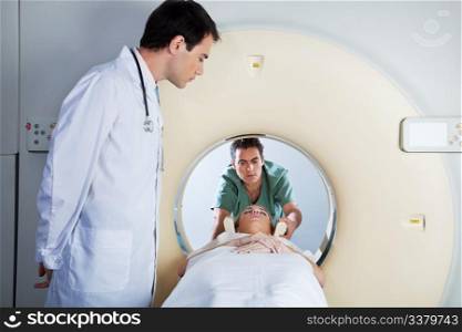 Doctor assisting the MRI scan with the technician in the laboratory