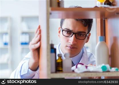 Doctor at farmacy retail shop looking for medicines. The doctor at farmacy retail shop looking for medicines