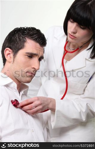 Doctor auscultating patient