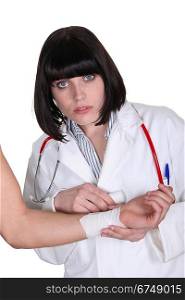 Doctor bandaging a patients arm