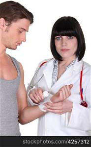 Doctor bandaging a wrist