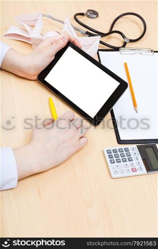 doctor calculates on tablet pc with cut out screen during appointment