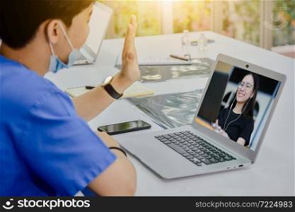 Doctor call video conference with wife,Doctor work at hospital call video social distancing