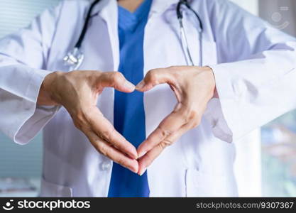 Doctor Cardiologist showing heart symbol with hand love and support to patients