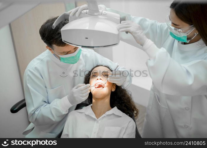 Doctor checking a patient?s teeth in dental clinic,People,Medicine,Stomatology and health care concept.