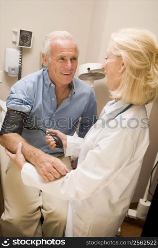 Doctor Checking Blood Pressure Of Man