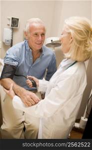 Doctor Checking Blood Pressure Of Man