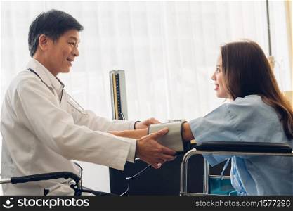 Doctor Checking Blood Pressure Of Patient At Medical Clinic