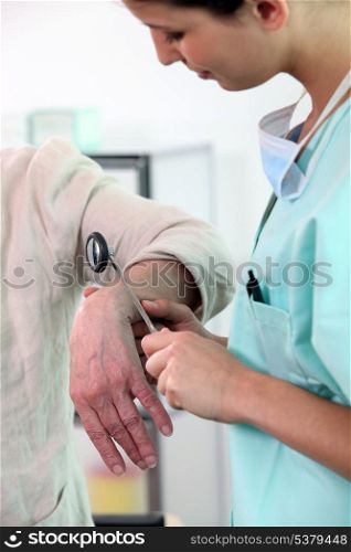 Doctor checking elderly patient