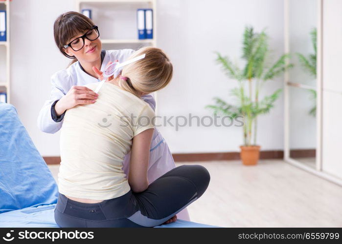 Doctor checking joint flexibility with goniometer