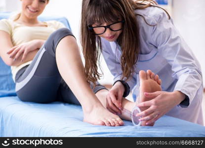 Doctor checking joint flexibility with goniometer