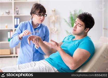 Doctor checking nerve reflexes with hammer