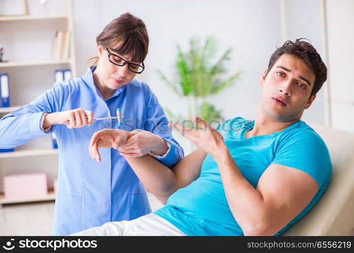 Doctor checking nerve reflexes with hammer