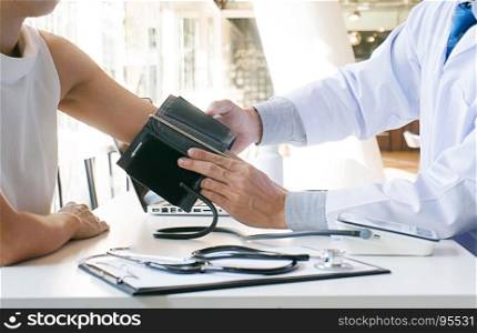 Doctor checking old woman patient arterial blood pressure. Health care.